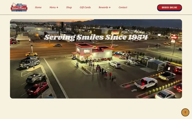 BJ's Velvet Freez homepage with an evening aerial of the drive-in under the headline Serving Smiles Since 1954